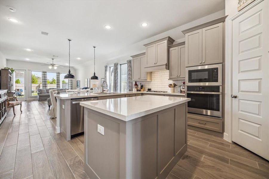 The kitchen features stainless steel appliances, quartz counter top and tons of storage