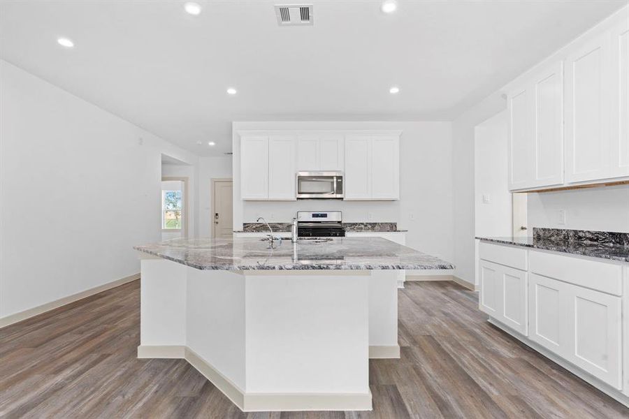 Amazing Eat In Working Station Island with stunning Granite Countertops! To your left down the hallway you will discover the Guest Bedroom tucked away! **Image Representative of Plan Only and May Vary as Built**