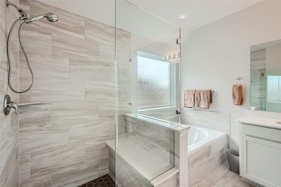 Take in the lovely and inviting amenities of this primary bathroom where your biggest daily challenge will be bath or shower?