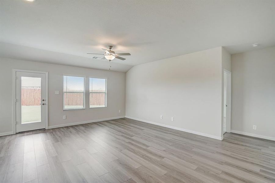 Living area with ceiling fan and light hardwood / wood-style flooring