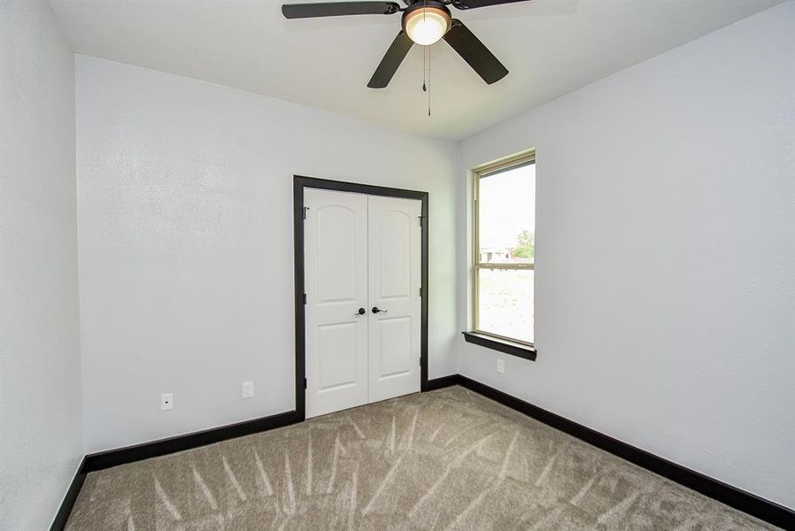 This good-sized room comes with a double-door closet and a fan and shares a full bathroom with another room.