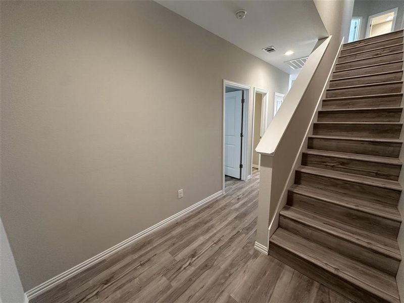 Stairs featuring wood-type flooring