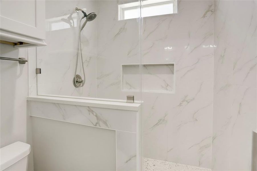 BEAUTIFUL SEAMLESS GLASS WALK-IN SHOWER LOCATED IN THE SECONDARY BATHROOM.