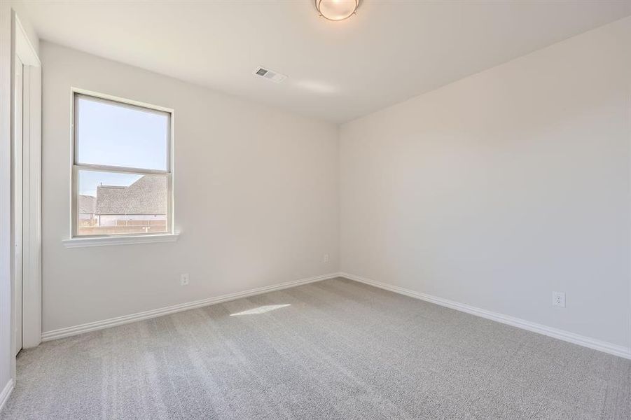 Unfurnished room with carpet