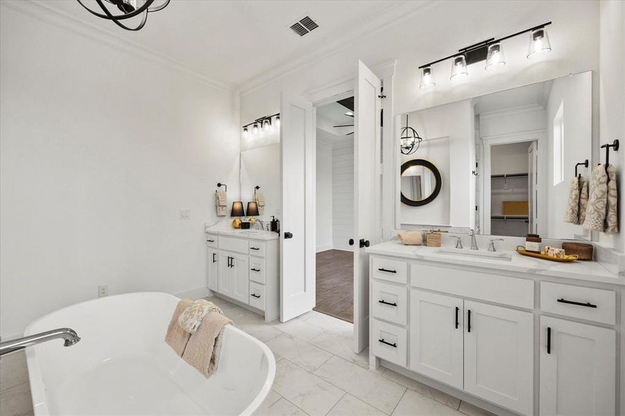 Bathroom featuring vanity, hardwood / wood-style floors, and crown molding