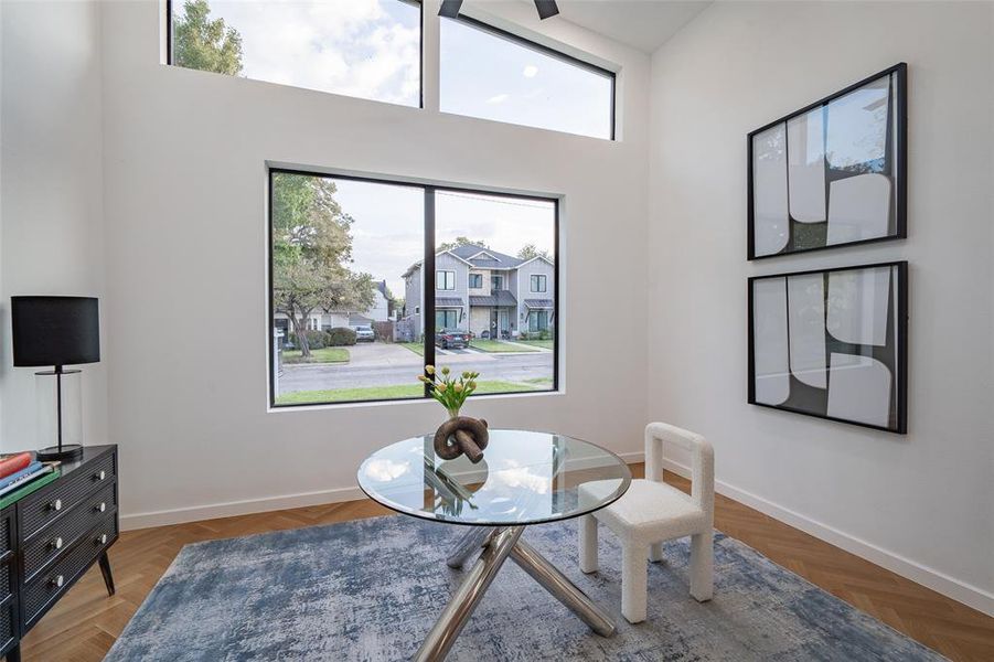 Office space with a high ceiling herringbone floors