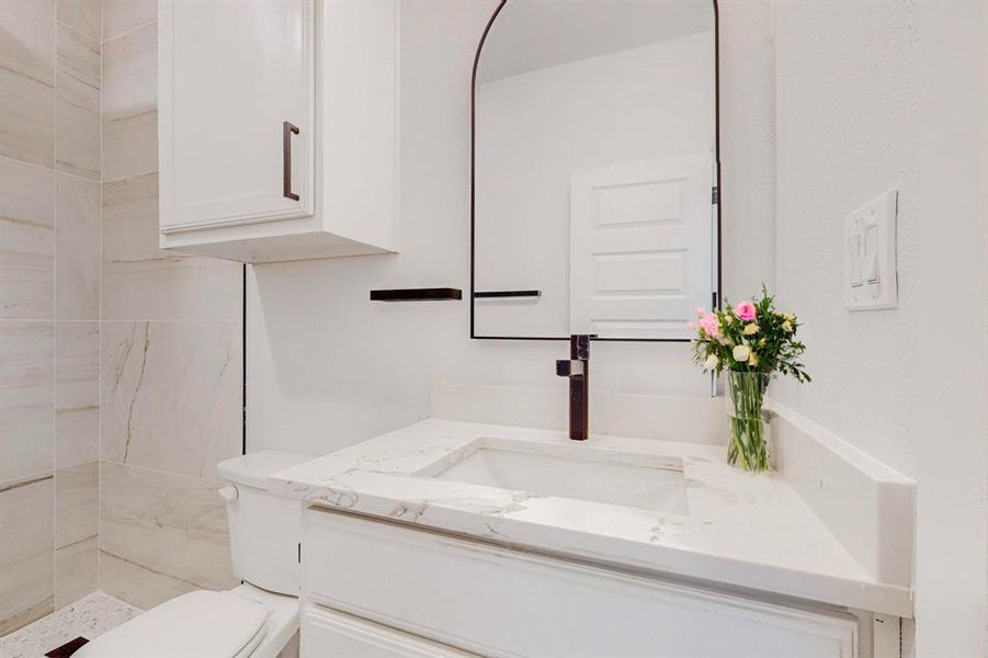 Staged Bathroom #2  featuring tiled shower, vanity, and toilet