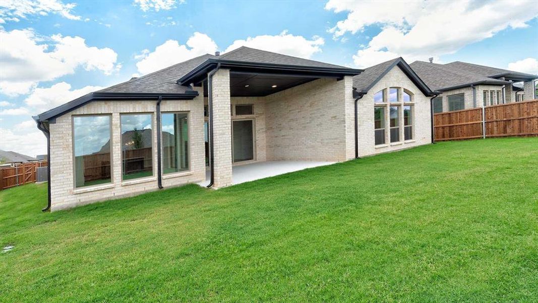 Back of property featuring a patio and a yard