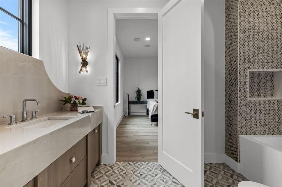 Bathroom featuring walk in shower, vanity, and hardwood / wood-style floors