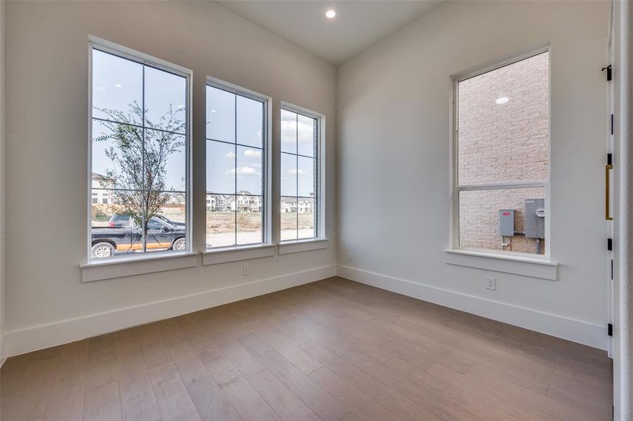 Unfurnished room with light wood-type flooring and a healthy amount of sunlight