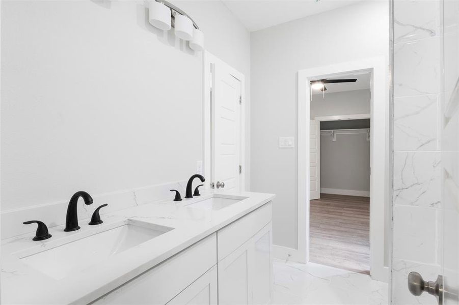 Bathroom with dual vanity and tile floors