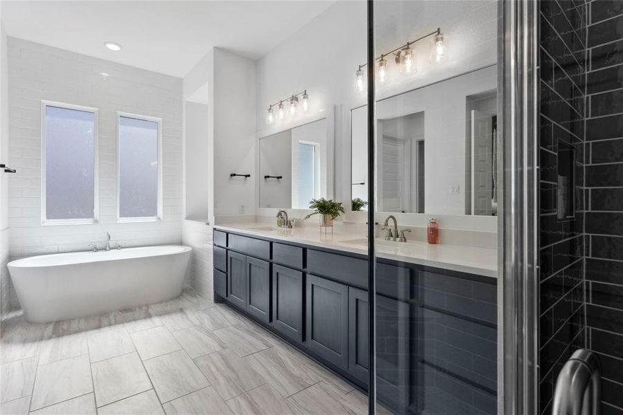 Spacious primary bath flooded with natural lighting