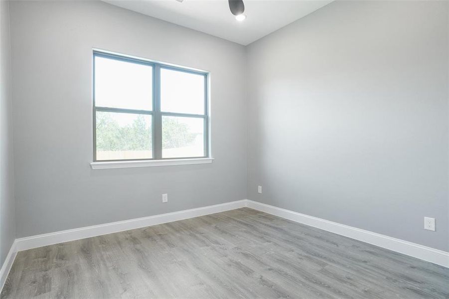 Empty room with ceiling fan and hardwood / wood-style floors