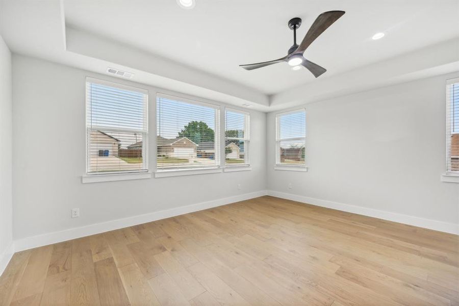 Unfurnished room with ceiling fan and light wood-type flooring