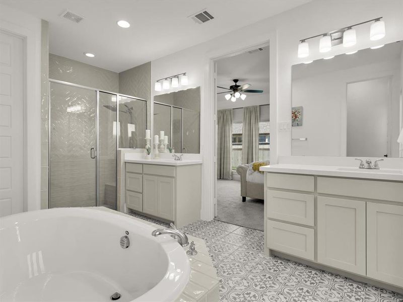 Owners ensuite featuring an oversized tub, dual vanities, and a walk-in shower.