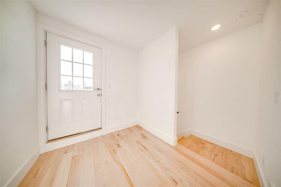 Entryway with hardwood / wood-style floors