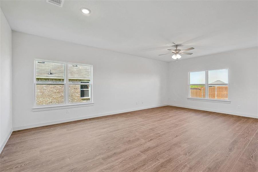 Unfurnished room featuring ceiling fan and light hardwood / wood-style flooring