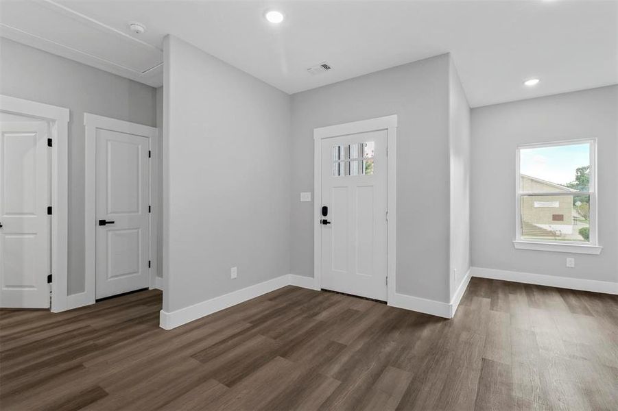 Entryway featuring a wealth of natural light and dark hardwood / wood-style flooring
