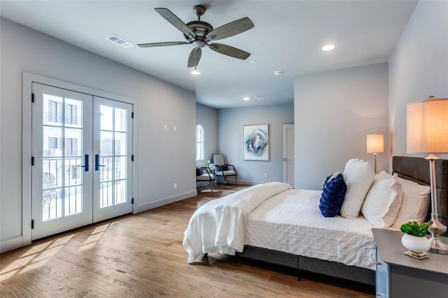 Bedroom featuring ceiling fan, light hardwood / wood-style flooring, access to exterior, and french doors