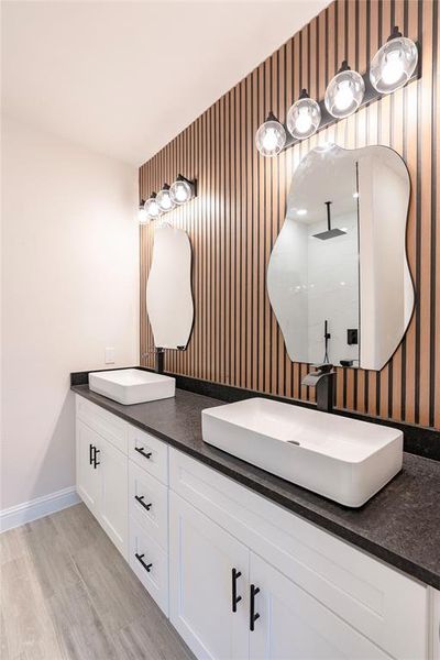 Bathroom featuring vanity and wood-type flooring