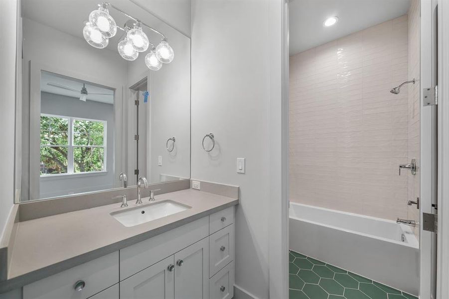 The en-suite bath features some fun, green tile floors and a walk-in closet!
