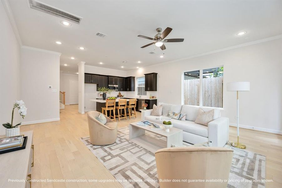 Recessed lighting and a stylish ceiling fan set the scene for tranquil evenings in the embrace of your expansive living room.