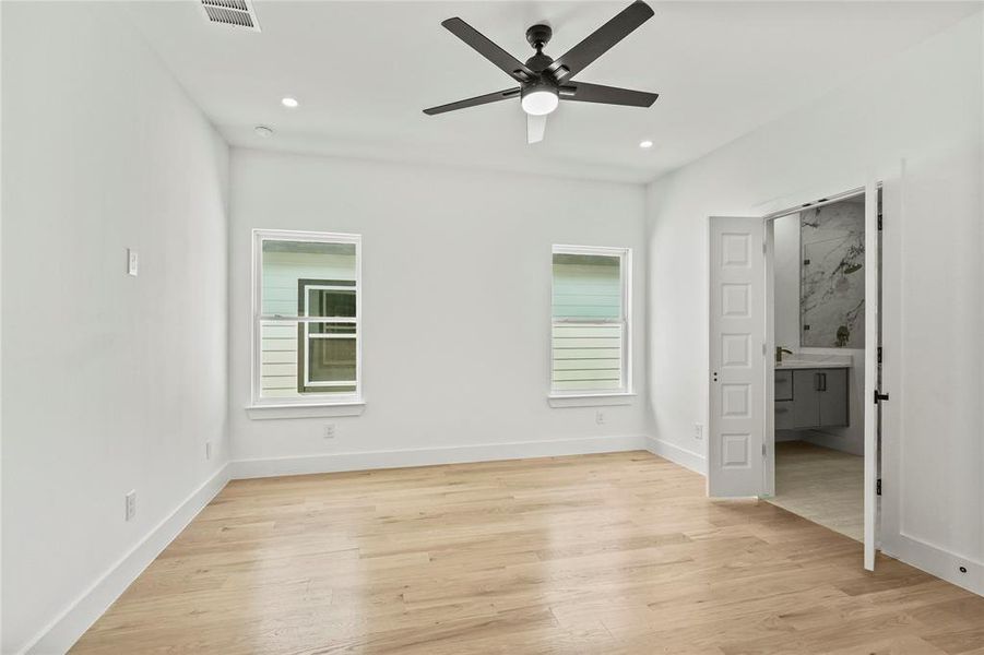 Unfurnished bedroom featuring ceiling fan and light hardwood / wood-style flooring