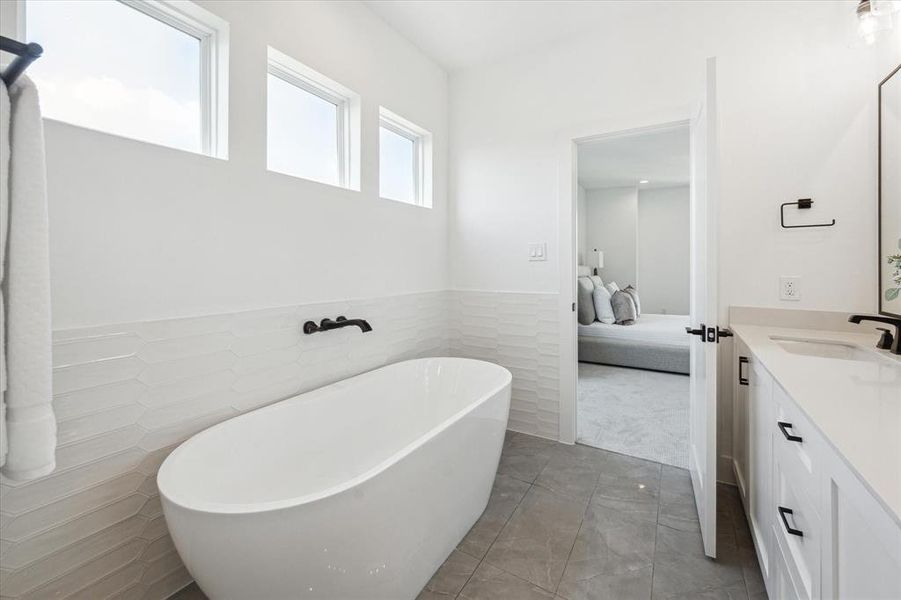 Large walk in shower with matte mosaic gray hexagon floor tiles.