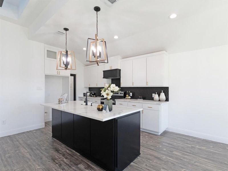 Kitchen with dark wood-type flooring, a center island with sink, decorative light fixtures, white cabinets, and electric stove