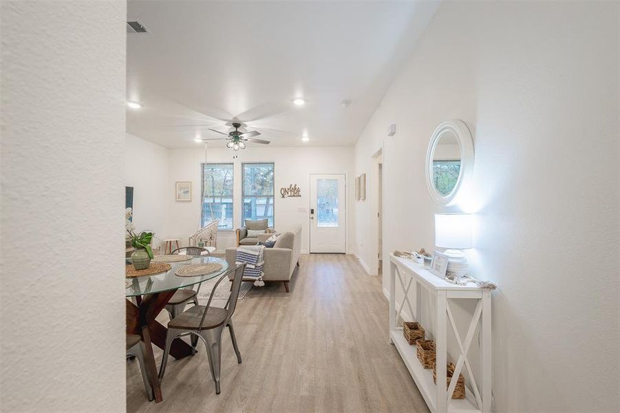 Dining area with light hardwood / wood-style floors and ceiling fan