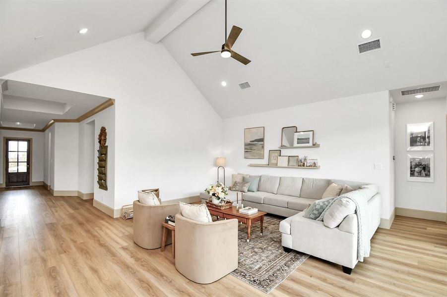 The living room boasts vaulted ceilings, recessed lighting and is prewired for sound.