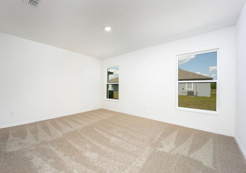 Two large windows in the master bedroom face the back yard