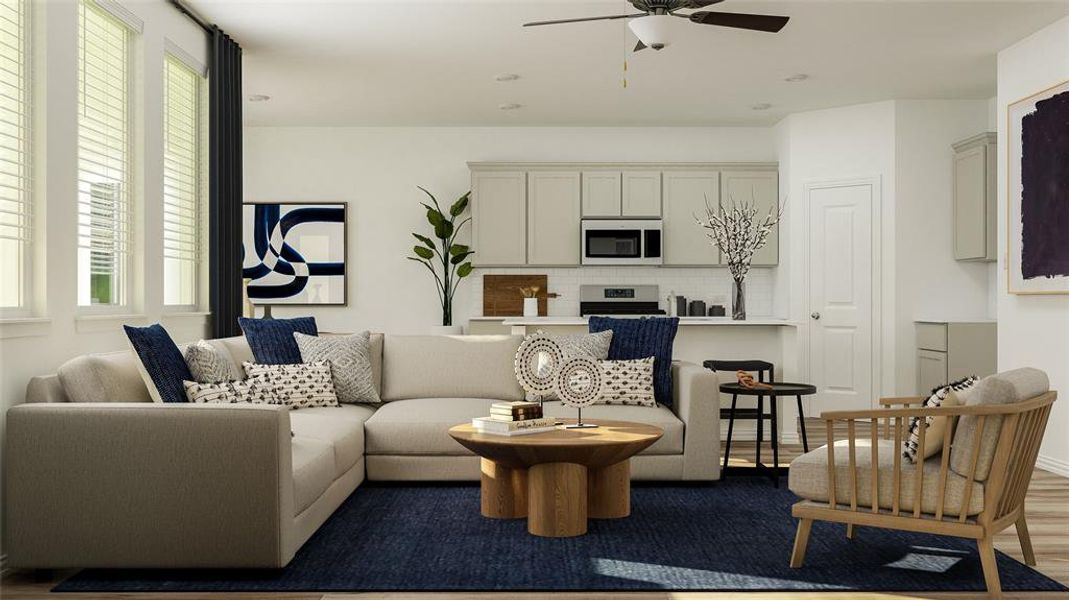 Living room featuring ceiling fan and hardwood / wood-style flooring