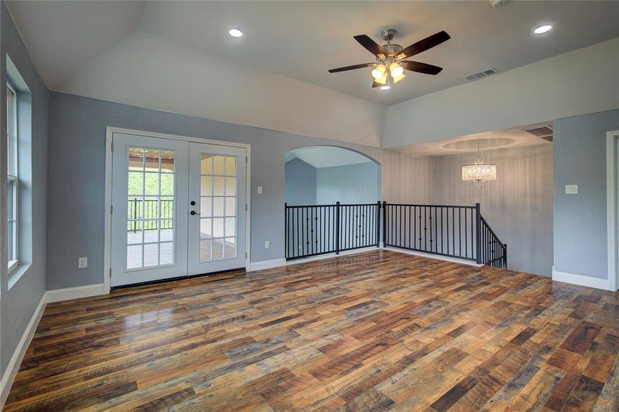 Upstairs living area with ceiling fan, french doors, and dark hardwood / wood-style flooring