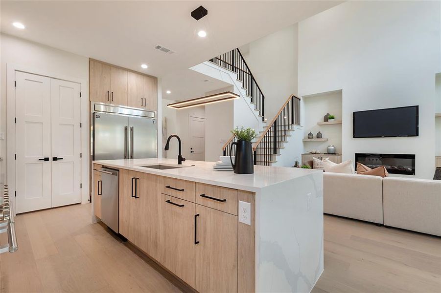Kitchen featuring a kitchen island with sink, light hardwood / wood-style flooring, appliances with stainless steel finishes, and sink