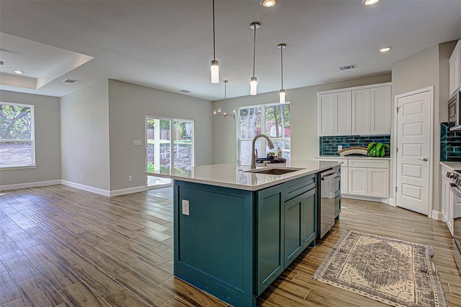 Open concept kitchen, dining, living.