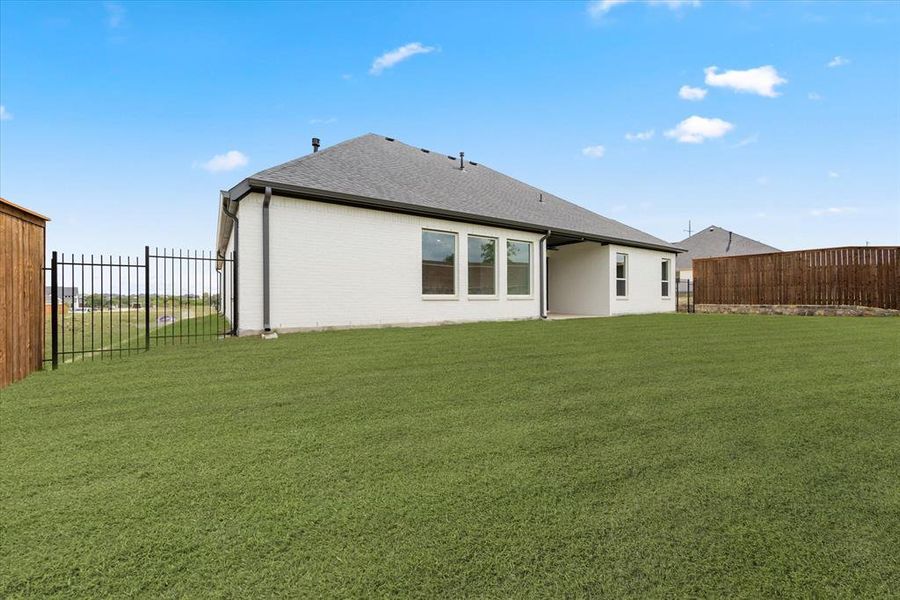 Rear view of property featuring a yard