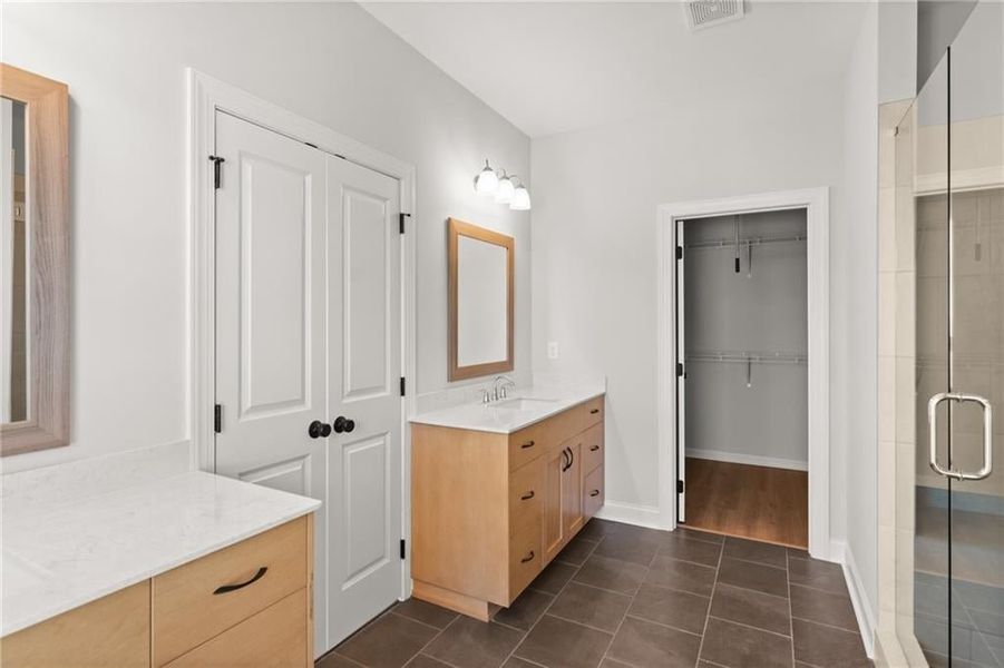 Homesite 13 will have separate white vanities with brushed gold hardware that provide ample space for storage and personal space for the morning routine. NOT actual home. Photos of previously built Grayton floorplan.