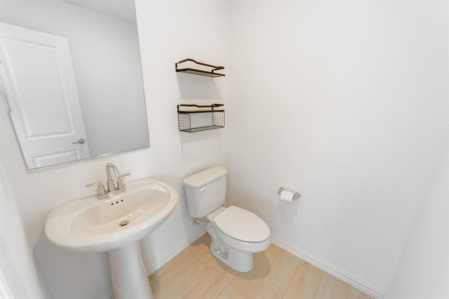 Bathroom with toilet and wood-type flooring