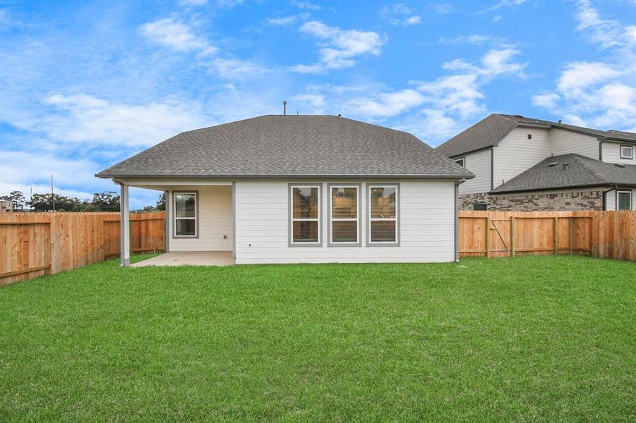 Step into a world of outdoor possibilities with this remarkable backyard and its charming covered patio. From playtime for the kids to relaxation for the adults, this space offers the best of both worlds.