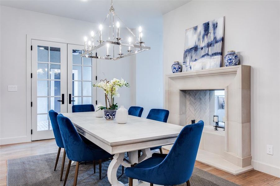 Dining room featuring french doors, hardwood / wood-style floors, and a chandelier