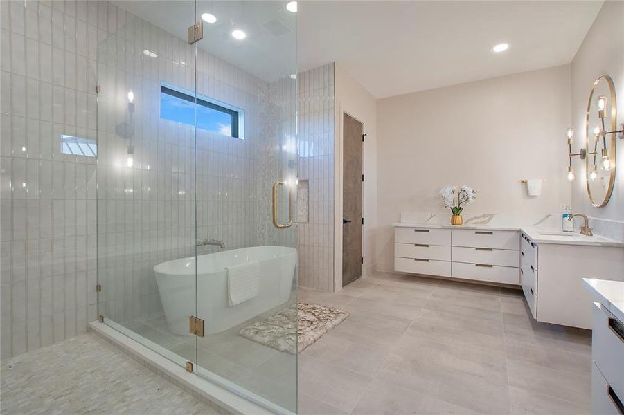 Bathroom featuring vanity, shower with separate bathtub, tile patterned flooring, and tile walls