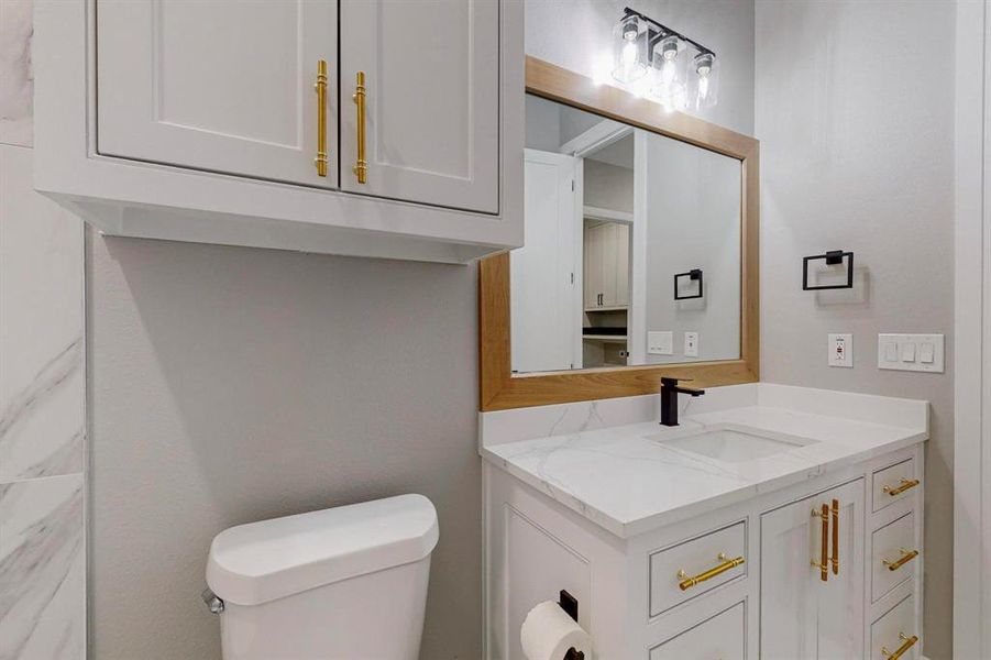 Bathroom featuring vanity and toilet