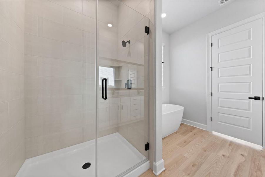 Master bathroom includes granite countertop, elongated mirror, and dual-vanity sinks. Relax in the large soaking tub or enjoy the spacious, standing shower.