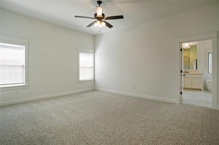 Unfurnished room featuring ceiling fan and light colored carpet