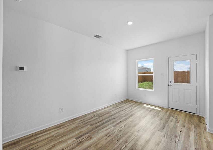 The dining room has a door that leads to the private backyard