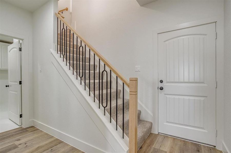 Stairway with hardwood / wood-style flooring