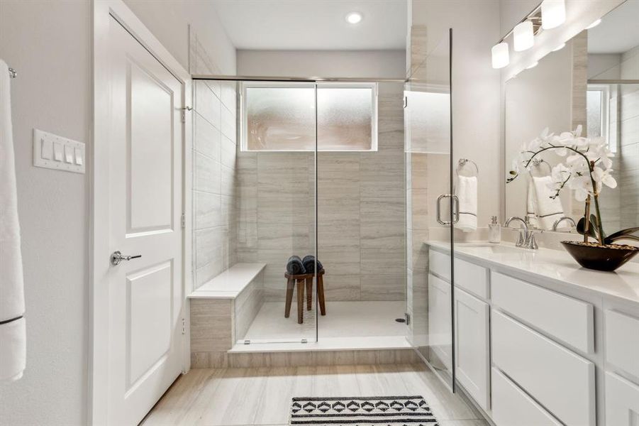 Bathroom featuring vanity and an enclosed shower