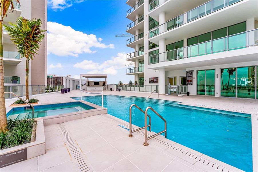 Pool with entertainment areas and an outdoor kitchen