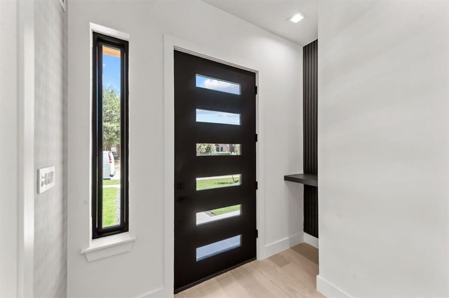 Entrance foyer featuring light wood-type flooring and a wealth of natural light